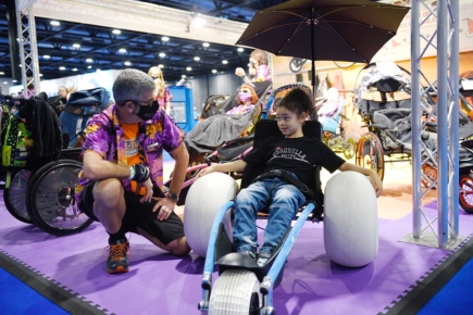 A child on a specialist wheelchair - Kidz to Adultz Exhibition