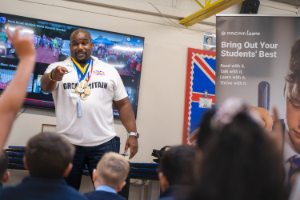 Kevin Brown in a classroom talking to pupils